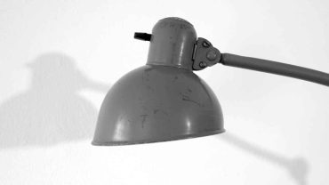 Moderne Schreibtischlampe in Grau, ideal für Arbeits- und Lernbereiche, mit flexiblem Arm für optimale Beleuchtung.